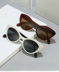 Close-up of retro cat-eye sunglasses in white and tortoiseshell on a geometric stand
