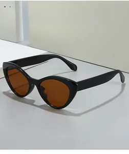 Side view of modern cat eye sunglasses with glossy black frames and dark brown lenses