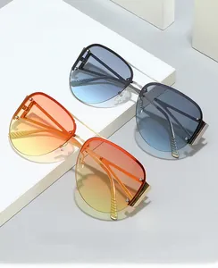 Detail of gradient blue and orange lenses with gold metal frames and striped temples