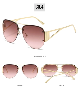 Detail view of pink gradient aviator sunglasses with gold frames and rivet accents