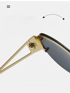 Close-up of durable metal hinges on square semi-rimless sunglasses in gold and grey