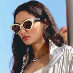 Fashionable beige cat-eye sunglasses with dark lenses for women in modern outdoor style