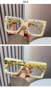 Macro view of birthday girl party glasses with white pearls and gold chain arms
