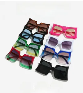 Flat lay of oversized geometric sunglasses in tortoise, pink, white and gradient colors