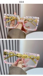 Detail of pink birthday girl glasses with pearl accents and gold chain link temples