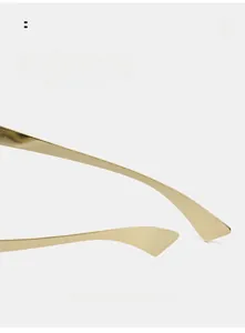 Detail of golden curved metal temples for lightweight punk futuristic sunglasses
