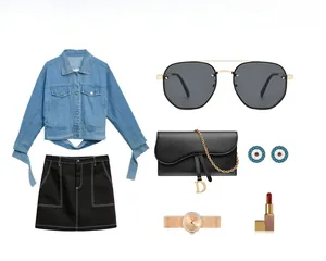 Flat lay of steampunk sunglasses paired with denim jacket and leather saddle bag accessory