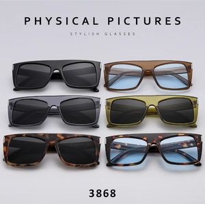 Detail view of multi-colored square frame sunglasses with metallic accents