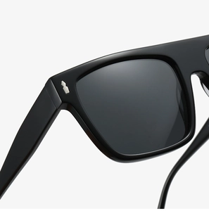 Macro detail of men's acetate sunglasses frame with polished silver metal rivets