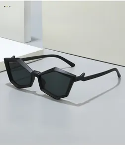 Detailed view of matte black pentagonal geometric frame sunglasses on minimalist grey surface