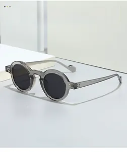Macro detail of translucent gray retro round sunglasses showing temple inner specs