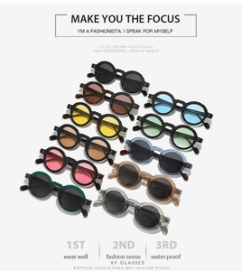 Multiple stylish retro small round sunglasses in various colors with metal rivet details