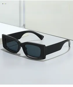 Close-up of gloss black square frame sunglasses on a minimalist white geometric display