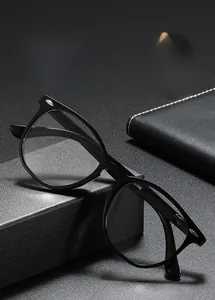 Detail of vintage oval reading glasses with rivets on a premium notebook and gift box