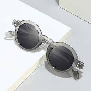 Retro small round frame sunglasses with translucent grey frames and dark lenses