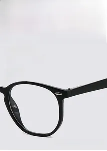 Detail of vintage oval glasses frame with metal rivets and flexible spring hinges