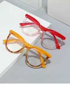 Detail view of large frame blue light blocking glasses in gradient red and yellow tortoise