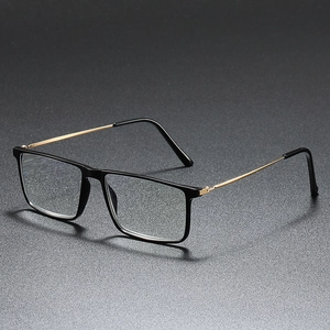 Classic black and gold rectangular business glasses with sleek metal temples on dark background