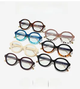 Flat lay of multiple colorful round frame anti-blue light glasses with metal temple details