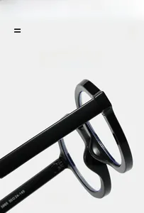 Detailed view of black frame eyeglasses with durable metal hinges and texture material