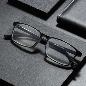 Ultralight TR90 black reading glasses with anti-blue light lenses on a business style desk