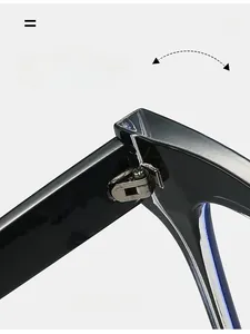 Macro detail of a durable silver metal hinge on polished black cat-eye glasses frames