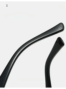 Close-up of sleek black curved temples on cat eye glasses with polished ergonomic finish