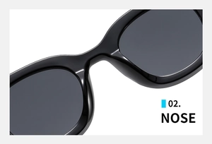 Close-up of integrated nose pads on black oval frame sunglasses with gray lenses