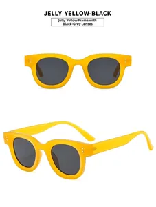 Detail view of jelly yellow retro chunky oval sunglasses with silver rivet accents