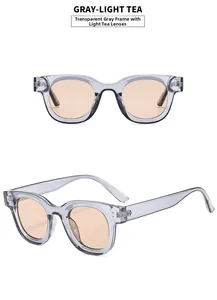 Detail of vintage oval sunglasses featuring a thick grey frame and light brown lenses