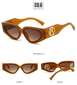 Detailed views of amber cat eye sunglasses featuring gold circular temple logo accents