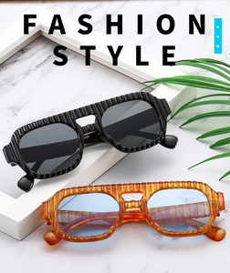 Detailed view of textured vertical stripe frames on retro double bridge sunglasses