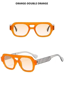 Detail of transparent orange pilot sunglasses with unique textured grey striped temples
