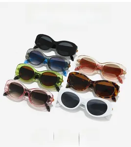 Flat lay of colorful oval sunglasses collection with acetate frames and metal hinges