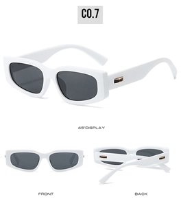 Detail view of white square sunglasses with dark grey lenses and gold metal accents