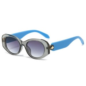 Oval beetle sunglasses with blue temples and gold snake detail on gray frames