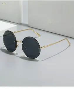 Detailed close-up of polygon sunglasses with gold metal temples on geometric white props