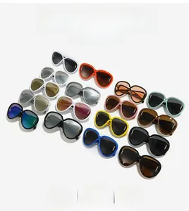 Flat lay of colorful oversized sunglasses in multiple frames like black, white and orange