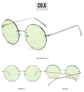Three-angle view of rimless round sunglasses with green lenses and silver metal frames