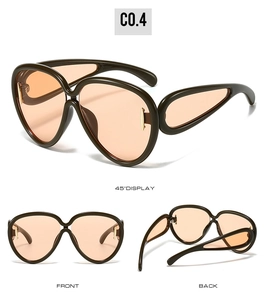 Three-angle display of oversized drop-frame sunglasses with amber lenses and gold accents