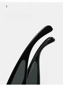 Macro shot of curved mirror legs on glossy black oversized sunglasses for comfort