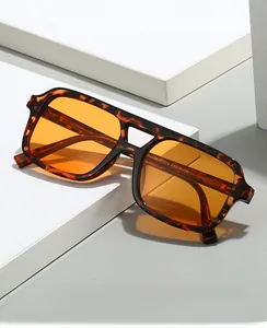 Close-up of vintage tortoise sunglasses with amber lenses on white geometric stands