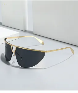 Close-up of minimalist gold metal frame with oversized black one-piece sunglasses lens