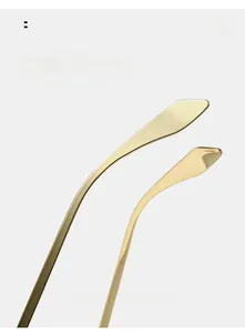 Close-up of golden curved metal sunglasses temples with ergonomic arc design detail