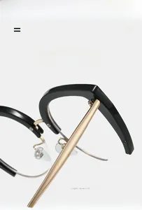 Close-up of golden metal hinge and high-quality screw detail on cat eye glasses frame