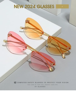 Close-up of frameless cat-eye sunglasses with gradient lenses and metal letter F detail