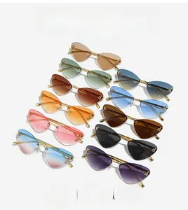 Detailed close-up of rimless cat-eye sunglasses featuring F-letter metal logo and rhinestones