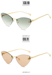 Detail view of rimless cat-eye sunglasses with F-shaped diamond metal trim and gradient lenses