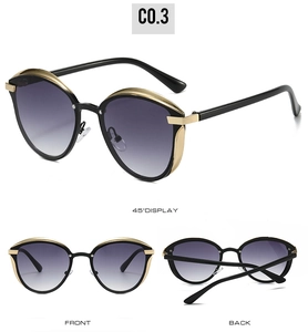 Cat eye sunglasses detail with gradient purple lenses and gold metal accents