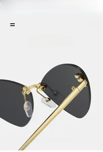 Detailed macro view of lightweight golden metal temples on rimless cat eye sunglasses